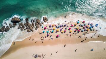 Top view of sandy beach with turquoise sea water and colorful blue umbrellas, aerial drone shot. . photo