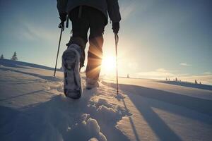 backpack in snowshoes climbs a snowy mountain, winter trekking, hiking equipment. . photo