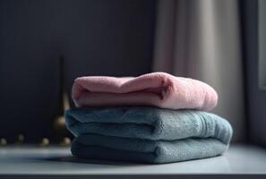 Stack of towels with a soap dispenser in a bathroom closeup. . photo