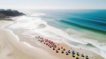 Top view of sandy beach with turquoise sea water and colorful blue umbrellas, aerial drone shot. . photo