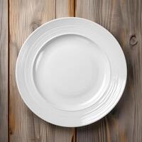 An empty plate on a white wooden table. Top view of white ceramic plate on white wooden. . photo