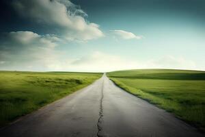 The landscape of grass fields and blue sky road leading off into the distance. . photo