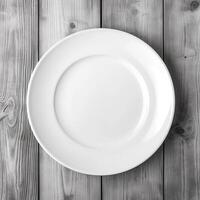 An empty plate on a white wooden table. Top view of white ceramic plate on white wooden. . photo