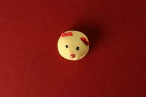 Chinese New Year rat mouse shaped cookie on red background photo