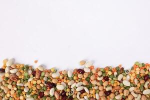 Mixed beans multi grain colorful mixture horizontal line frame border copy text space on white background photo