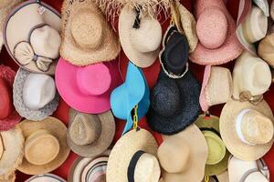 Hat shop display colorful variety hats hanging on the wall photo