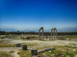 old ruins of the Roman spa city of Hierapolis on the site of the current poison on a warm summer sunny day photo