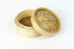 Wooden bamboo dim sum steamer on white background photo