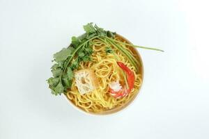 Fresh yellow egg noodle prawn tofu coriander leaf in bowl on whit background photo