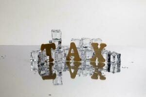 Tax alphabet ice cube freeze cool on white background photo