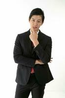 South East Asian young Chinese man wearing formal business office ware on white pose hand on cheek photo