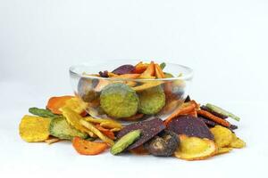 Healthy vegetable chips yellow sweet potato purple sweet potato carrot green radish green beans and shiitake mushrooms in glass bowl photo