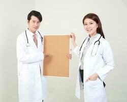 Young Asian male female doctor wearing apron uniform tunic apron hold photo