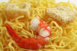 Fresh yellow egg noodle prawn tofu on whit background photo