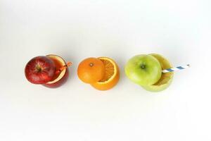 Healthy Red Green Cut Apple Orange recyclable paper straw juice drink idea concept on white background photo