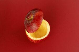 Healthy Red Cut Apple floating top slice juice drink idea concept on red background photo