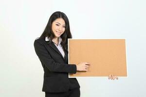 One young Asian Malaysian business office woman holding blank copy text space sign board on white background photo