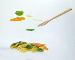 Dry preserved green kiwi pineapple ripe fruit slice colorful sweet on black marble slate background flying floating elevated drooping photo