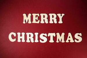 Merry Christmas sign on red paper background color wooden alphabet photo