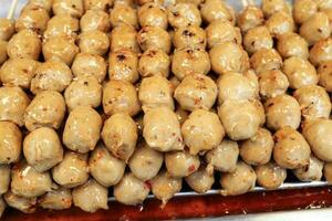 sausage meat ball on skewer selling at street stall photo