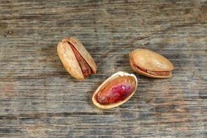 Pistachio nuts shell on rustic wood photo