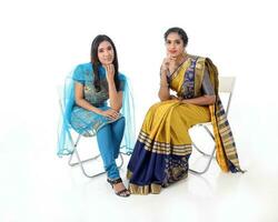 Two South east Asian Indian race ethnic origin woman wearing Indian dress costume sharee and salwar kameez multiracial community on white background photo