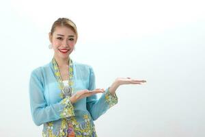 Asian woman traditional blue orange kebaya sharong on white  background palm hand show display photo