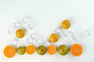 small yellow green mandarin ice cube orange whole slice on white background copy space for text frame border photo