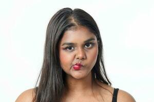 Young attractive Asian Indian woman pose face body expression mode emotion on white background lips twist wicked photo