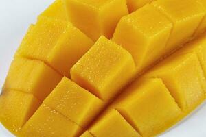 ripe yellow mango cut slice whole on white background photo