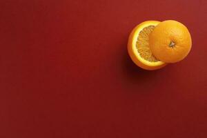 Healthy Orange Cut floating top slice juice drink idea concept on red background photo