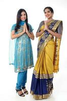 Two South east Asian Indian race ethnic origin woman wearing Indian dress costume sharee and salwar kameez multiracial community on white background photo