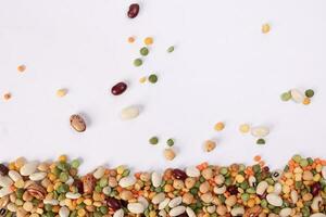 Mixed beans multi grain colorful mixture horizontal line frame border copy text space on white background photo