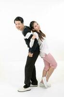 South East Asian young Chinese couple husband wife back to back holding hands on white background happy love photo