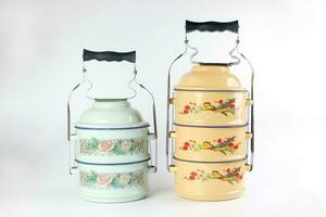 Vintage retro tin tiffin food two three tier carrier on white background photo