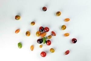 Fresh ripe mixed tomato verity assorted color on white background photo