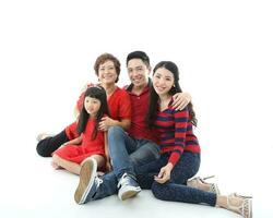 Southeast Asian multigeneration family parents daughter grandmother father mother child pose happy sit stand photo