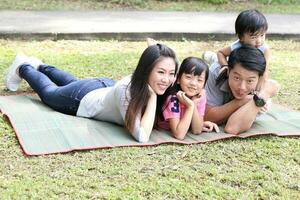 South East Asian young father mother daughter son parent boy girl child activity outdoors park photo