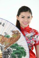 South East Asian young Malay Chinese Indian man woman wearing traditional chinse cheongsam dress on white background shop exchange gift orange greetings share racial unity harmony hand fan photo