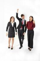 Young attractive one man two woman business office white background walk joy happy success hand fist in the air photo