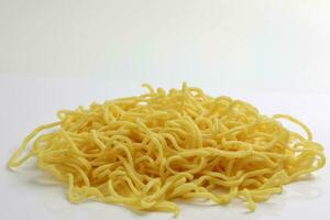 Fresh yellow egg noodle on whit background photo