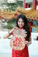 Young south east asian Chinese man woman traditional costume Chinese new year greeting outdoors at temple photo