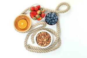 Blueberry Strawberry Herb Spice Almond Cashew Nut Mandarin Orange in bowl on white background photo