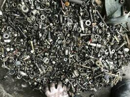 Metal Junk nuts bolts sparkplugs dusty dirty old trash photo
