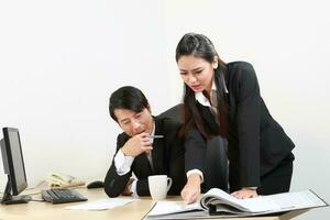 Young Asian man woman wearing business office suit chair table computer white background photo