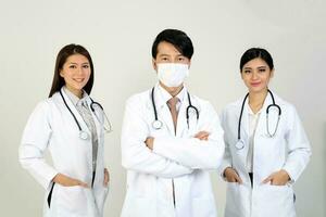 Young Asian male female doctor wearing apron stethoscope cross arm look at camera photo