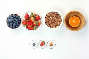 Blueberry Strawberry Herb Spice Almond Cashew Nut Mandarin Orange in bowl on white background photo