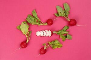 Small red radish on red ackground photo