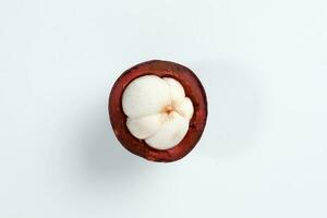 Purple mangosteen fruit pealed half on white background photo