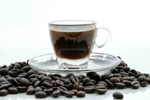 Small glass transparent coffee cup saucer full coffee beans photo